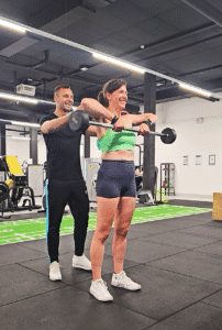 Happy gym training personal trainer with client